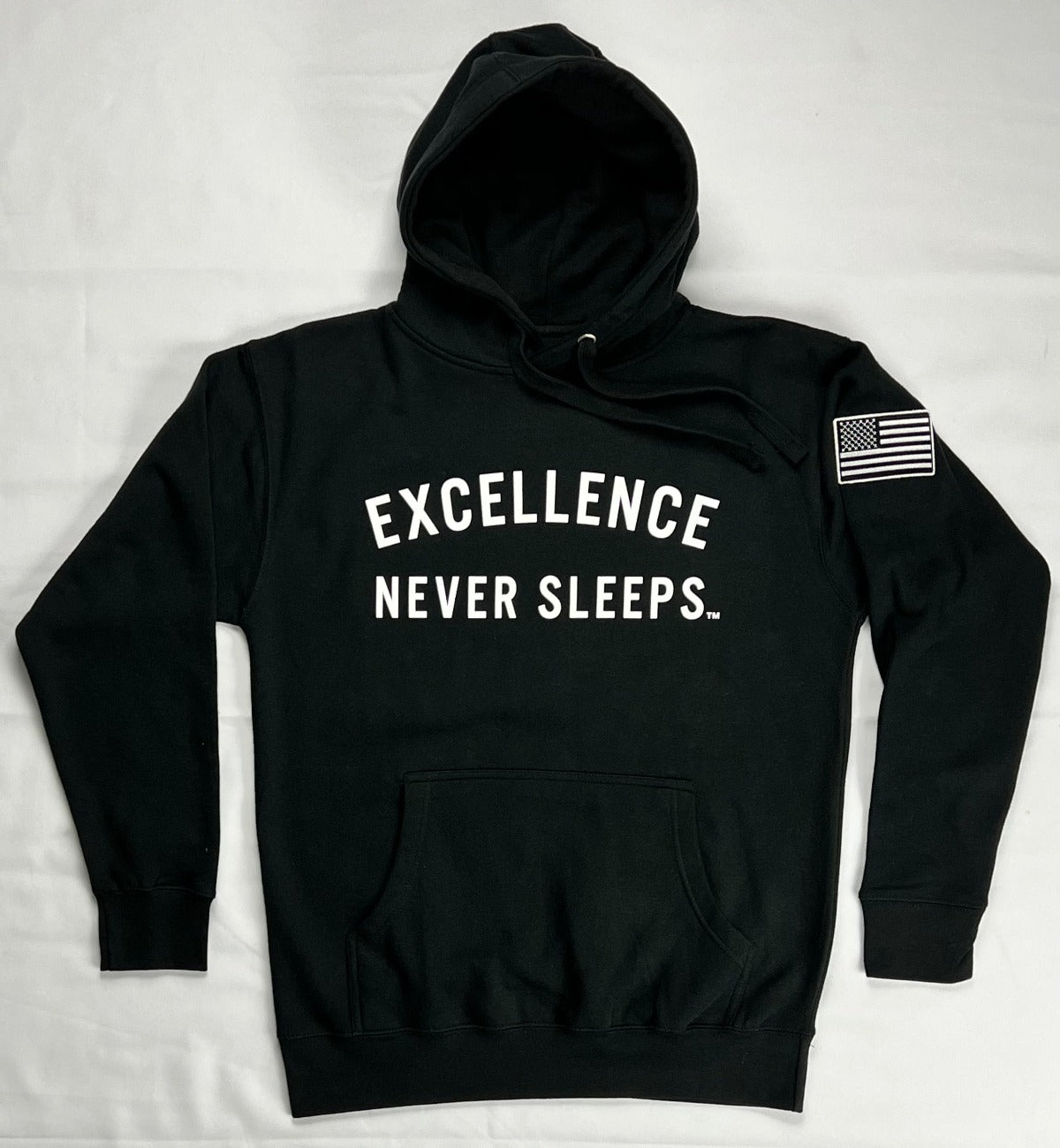 Excellence Never Sleeps Printed graphic on front. Printed graphic on back. Embroidered Patch Sewn on Left Sleeve. 8.5 oz Soft-Washed Comfort Weight Fleece Facing yarn (outside print surface) is 100% Cotton 65% Ringspun Cotton 35% Polyester. Sizes: S-M-L-XL-2XL Color: Black