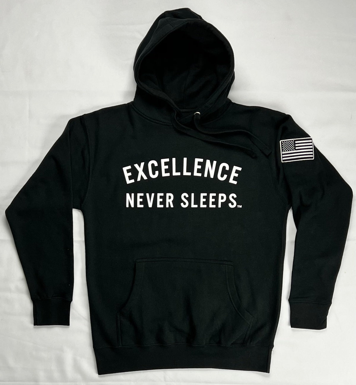 Excellence Never Sleeps   Printed graphic on front. Printed graphic on back.  Embroidered Patch Sewn on Left Sleeve.   8.5 oz Soft-Washed Comfort Weight Fleece  Facing yarn (outside print surface) is 100% Cotton  65% Ringspun Cotton 35% Polyester.  Sizes: S-M-L-XL-2XL  Color: Black